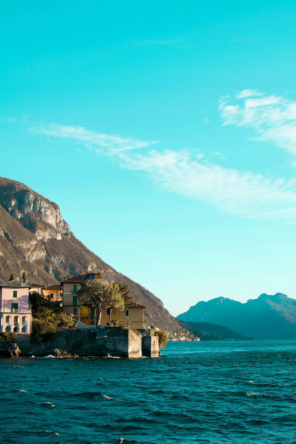 a body of water with a mountain in the background