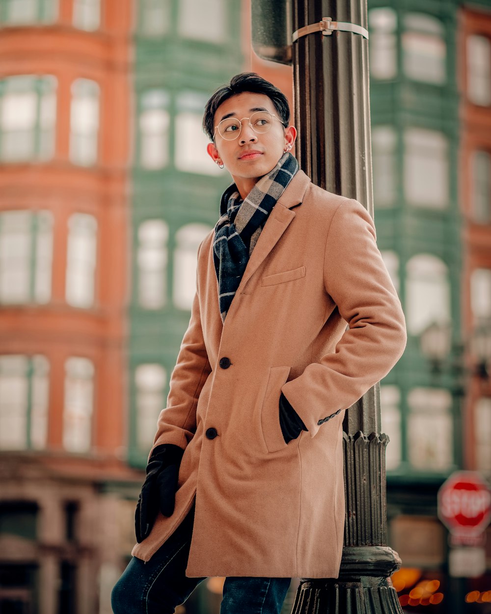 a man standing next to a pole in front of a building