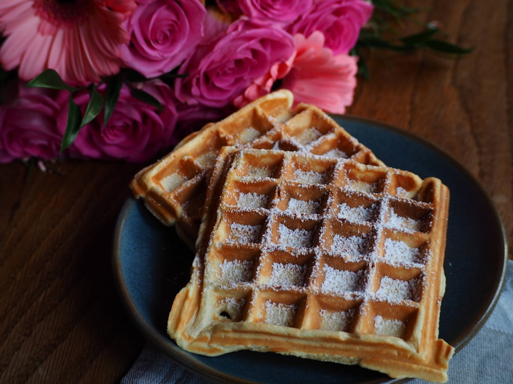 a couple of waffles sitting on top of a blue plate