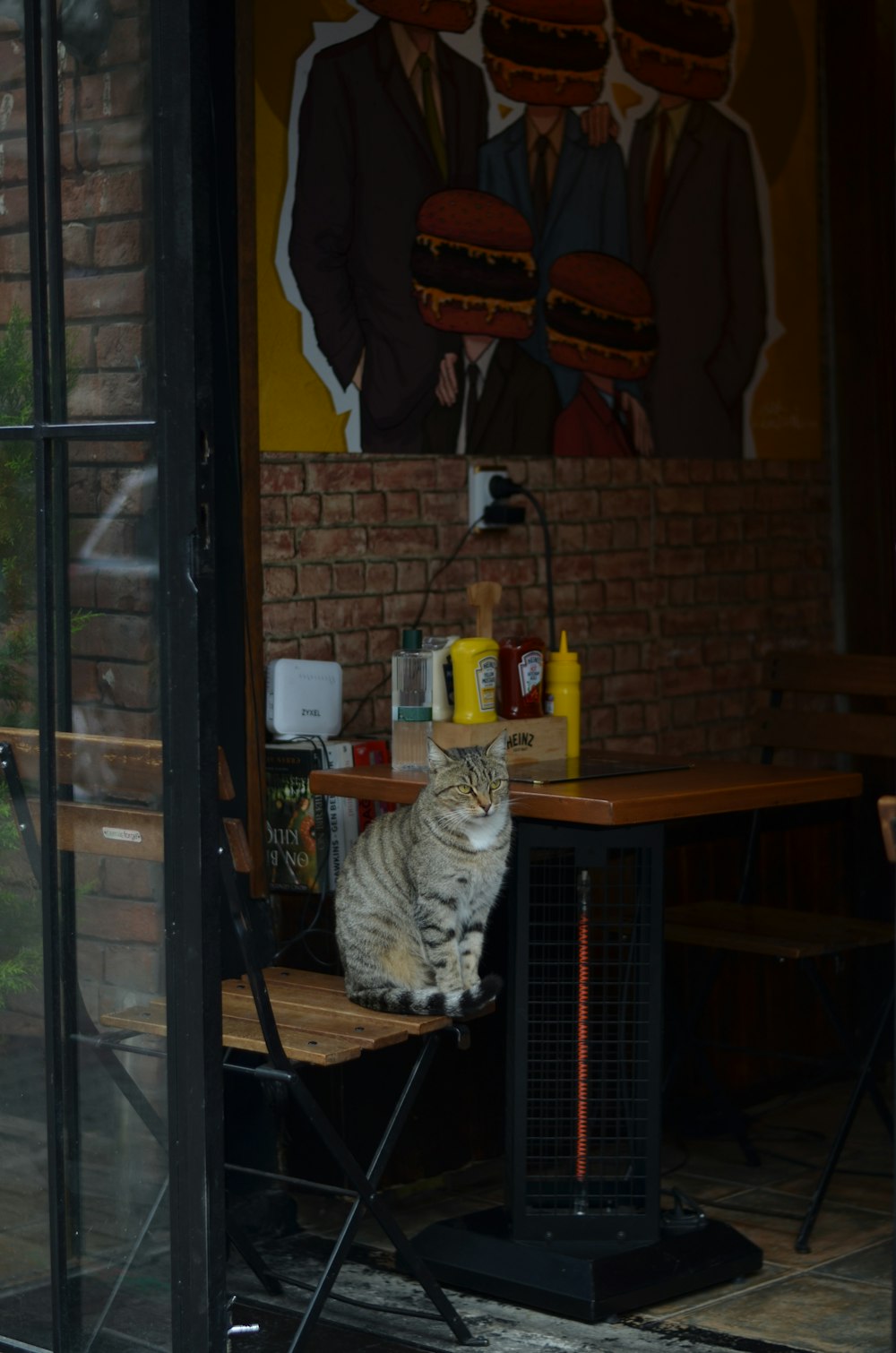 a cat sitting on a chair in a restaurant