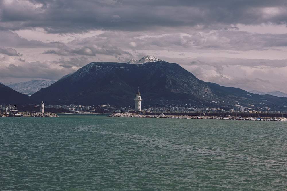 a body of water with mountains in the background