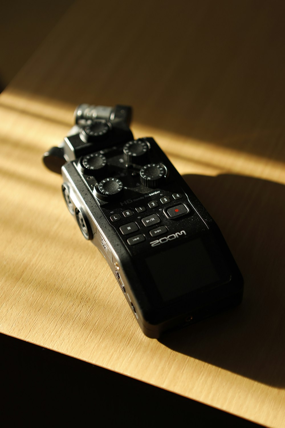 a remote control sitting on top of a wooden table