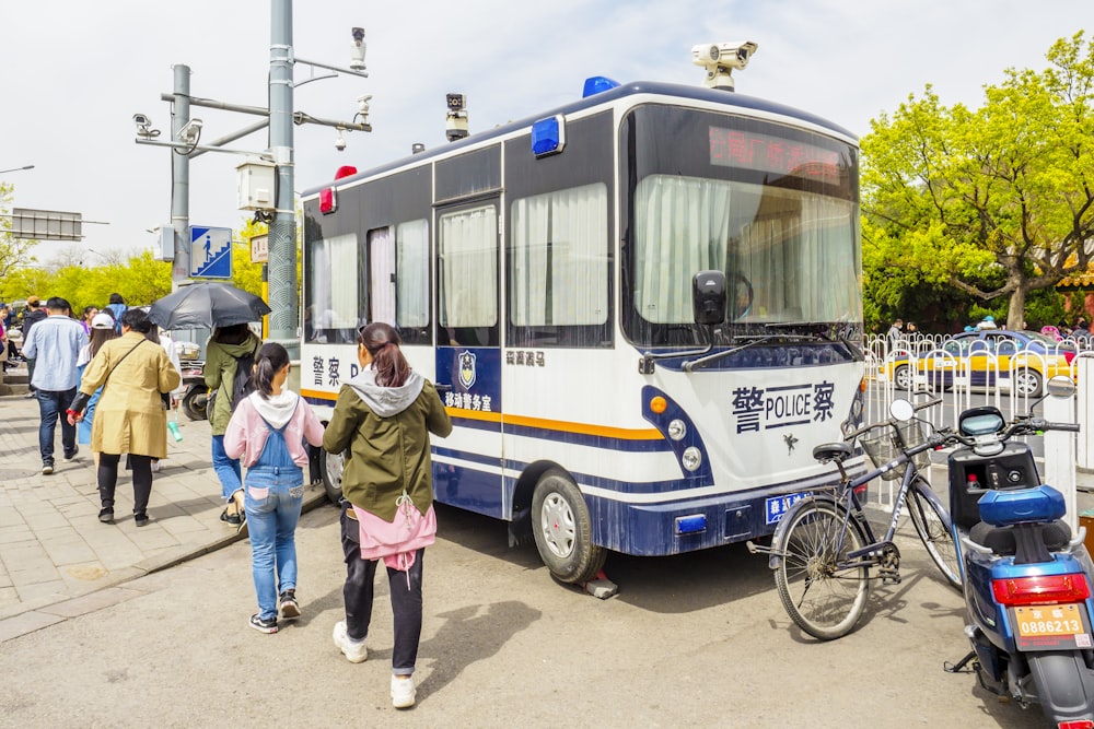 a group of people walking next to a bus