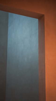 an empty room with a white wall and a clock