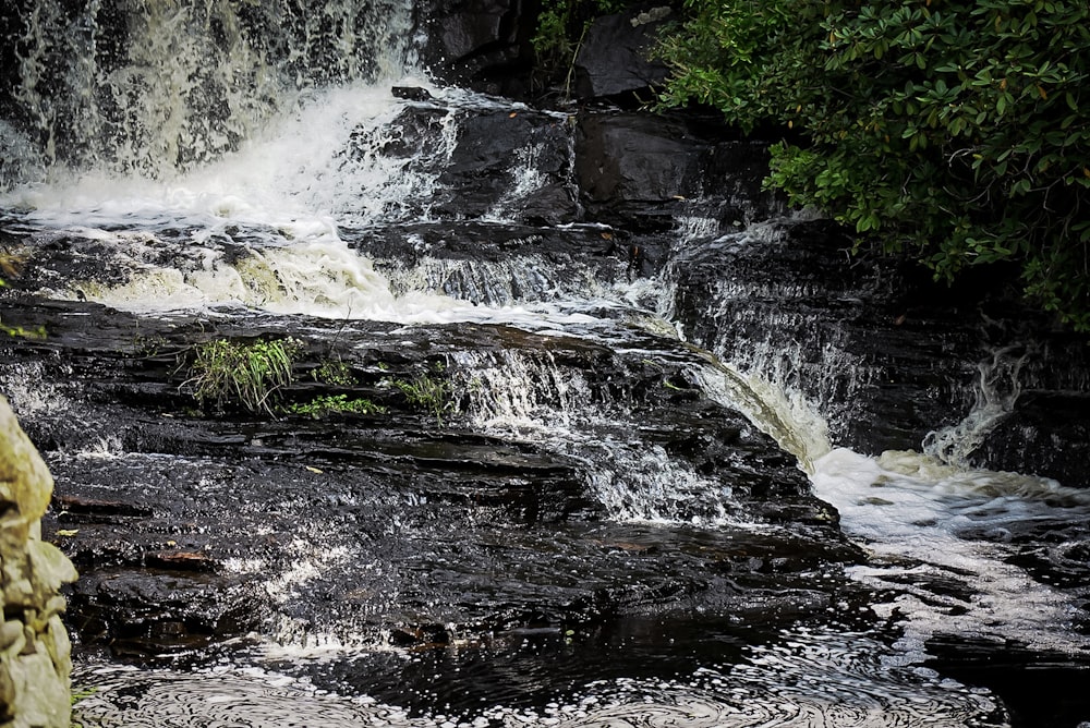 a waterfall with water cascading over it