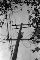 a black and white photo of a telephone pole