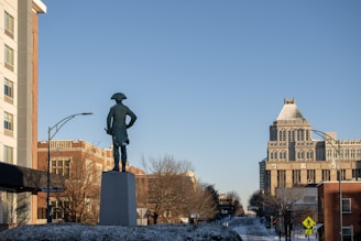 a statue of a man standing in the middle of a street