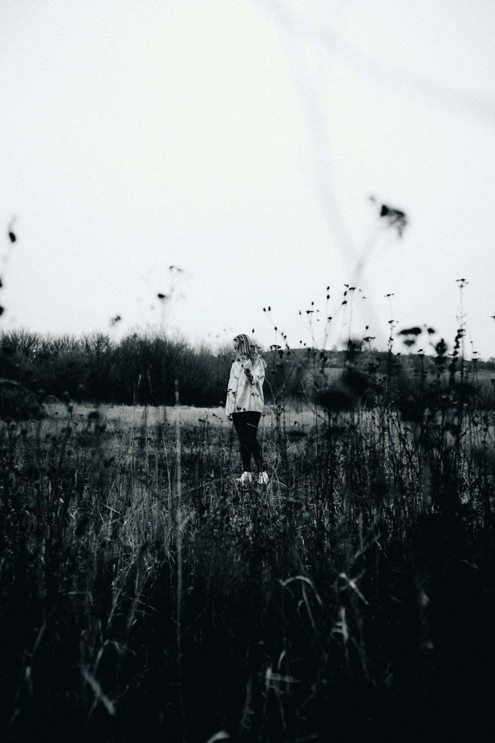 a person standing in a field of tall grass