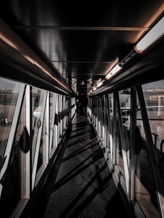 a long hallway with lots of windows next to an airport