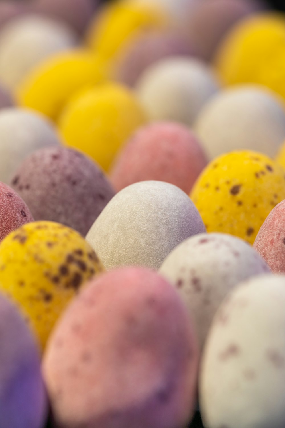 a close up of many different colored candies