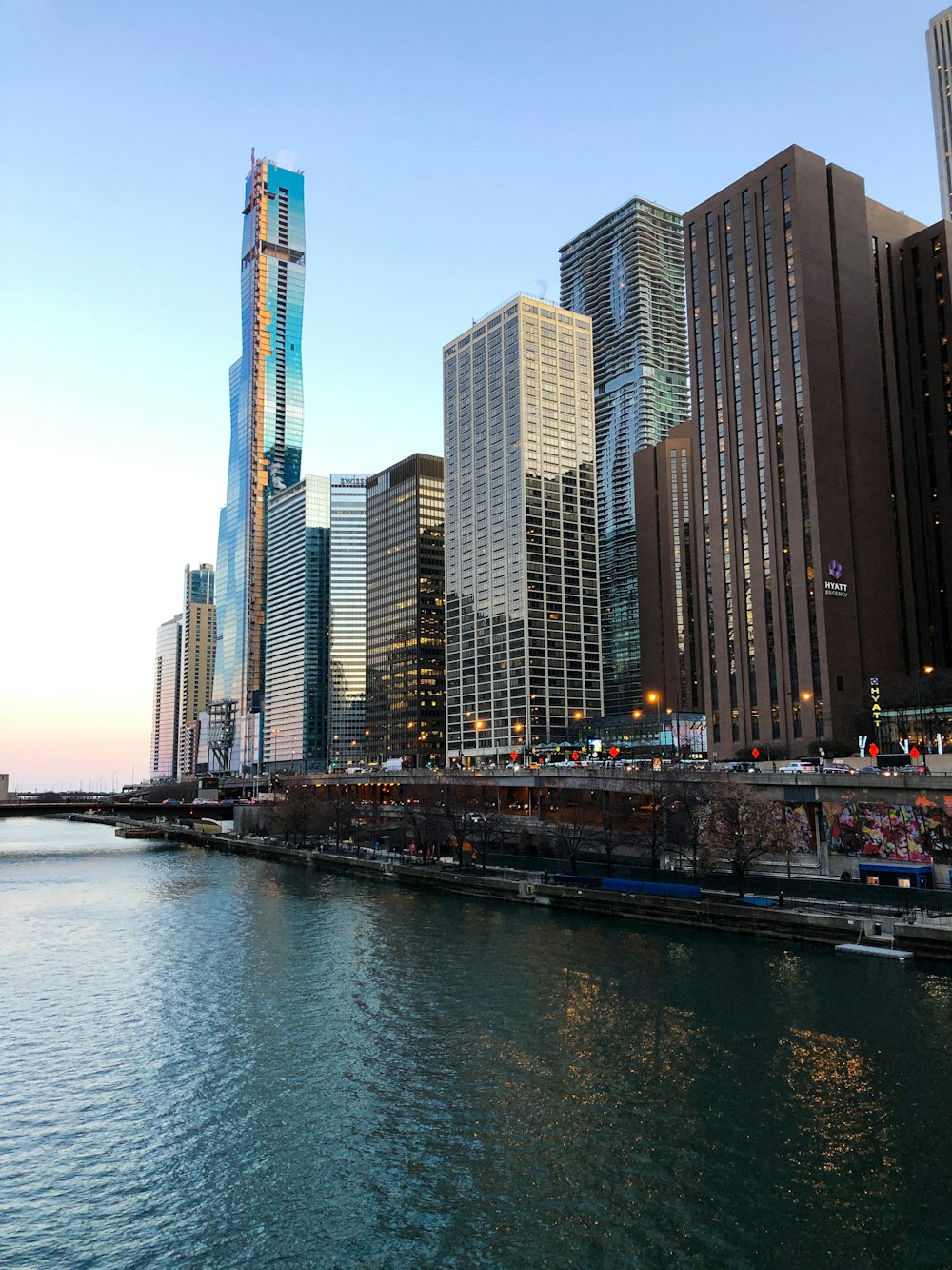 a body of water in front of tall buildings