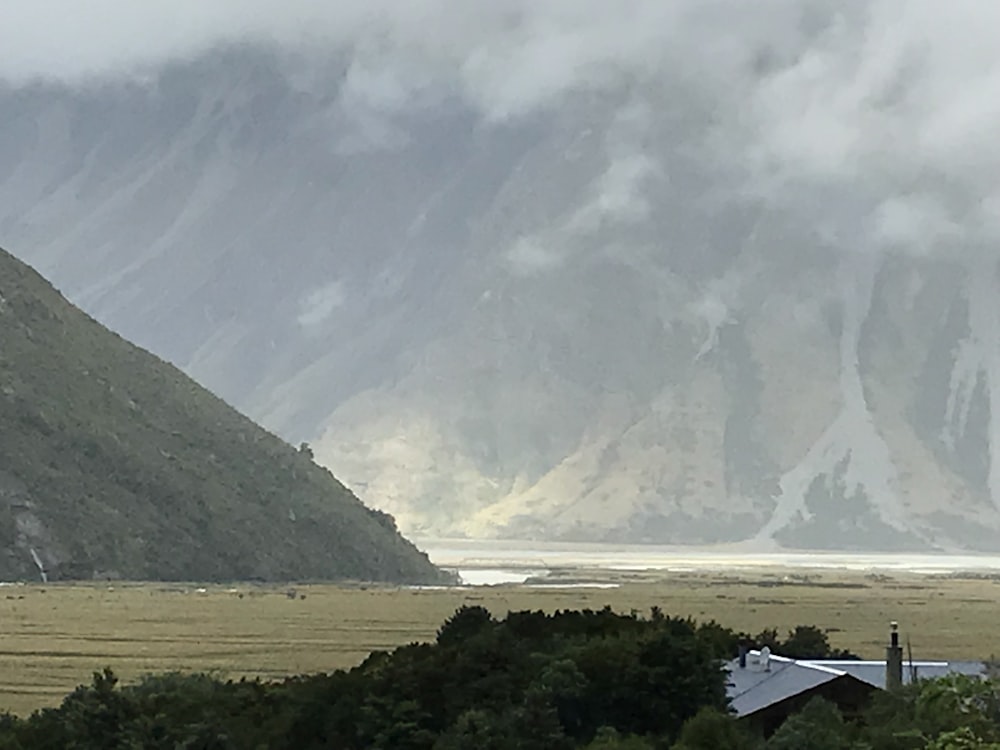 a view of a mountain range with a house in the foreground