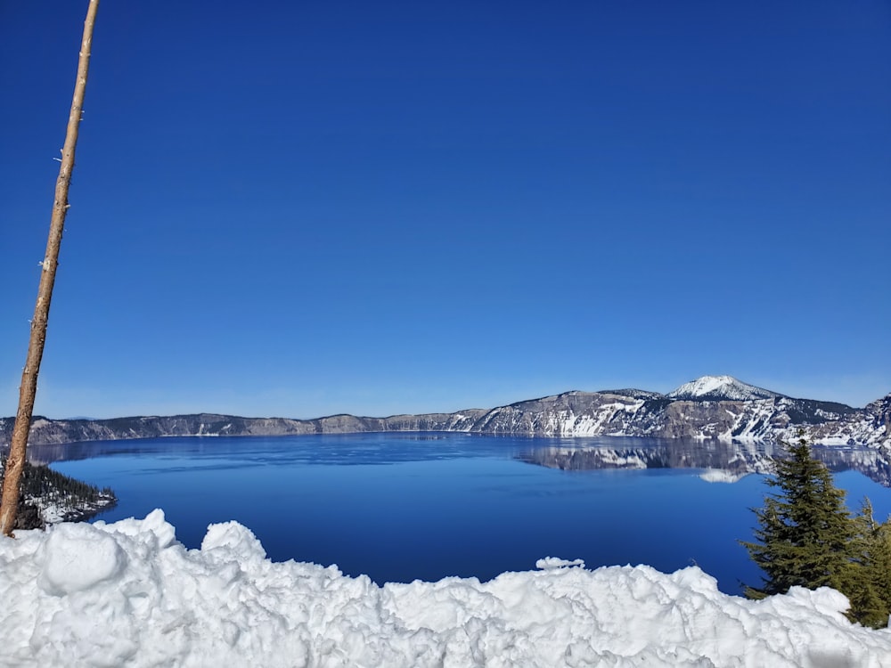 a large body of water surrounded by snow