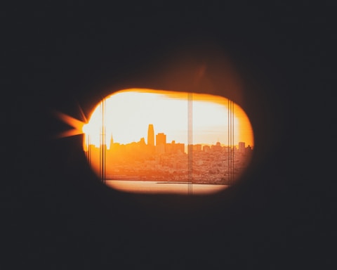a view of a city through a hole in a wall