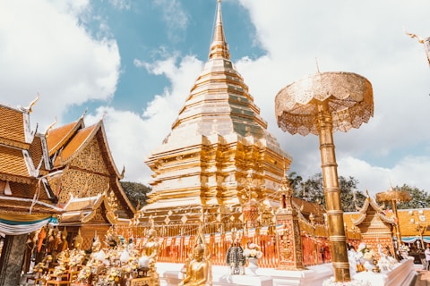 a gold and white building with a sky background