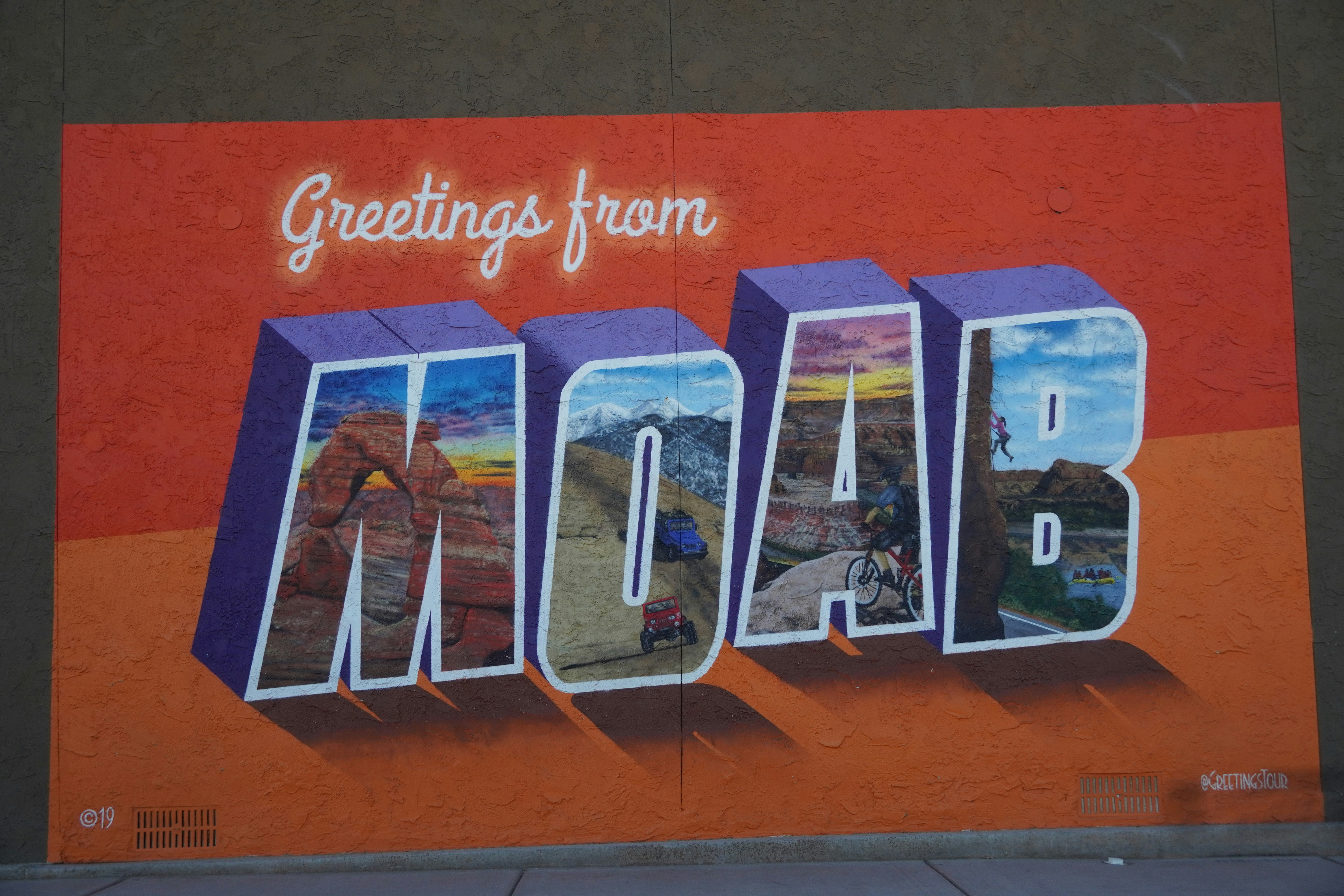 a mural of the word moab painted on the side of a building