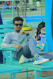 A relaxed man in casual Lacoste wear enjoying a sunny day outdoors.
