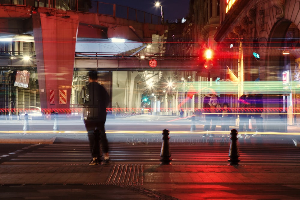 a blurry photo of a man standing on a street corner