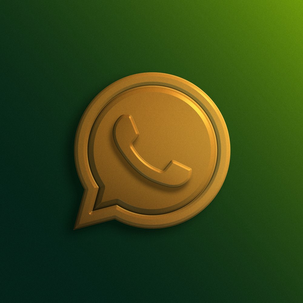 a gold phone icon on a green background