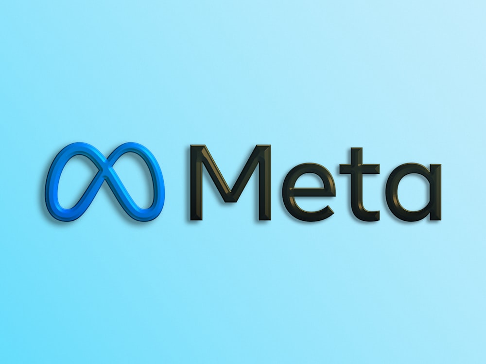 a blue and black logo with the word meta