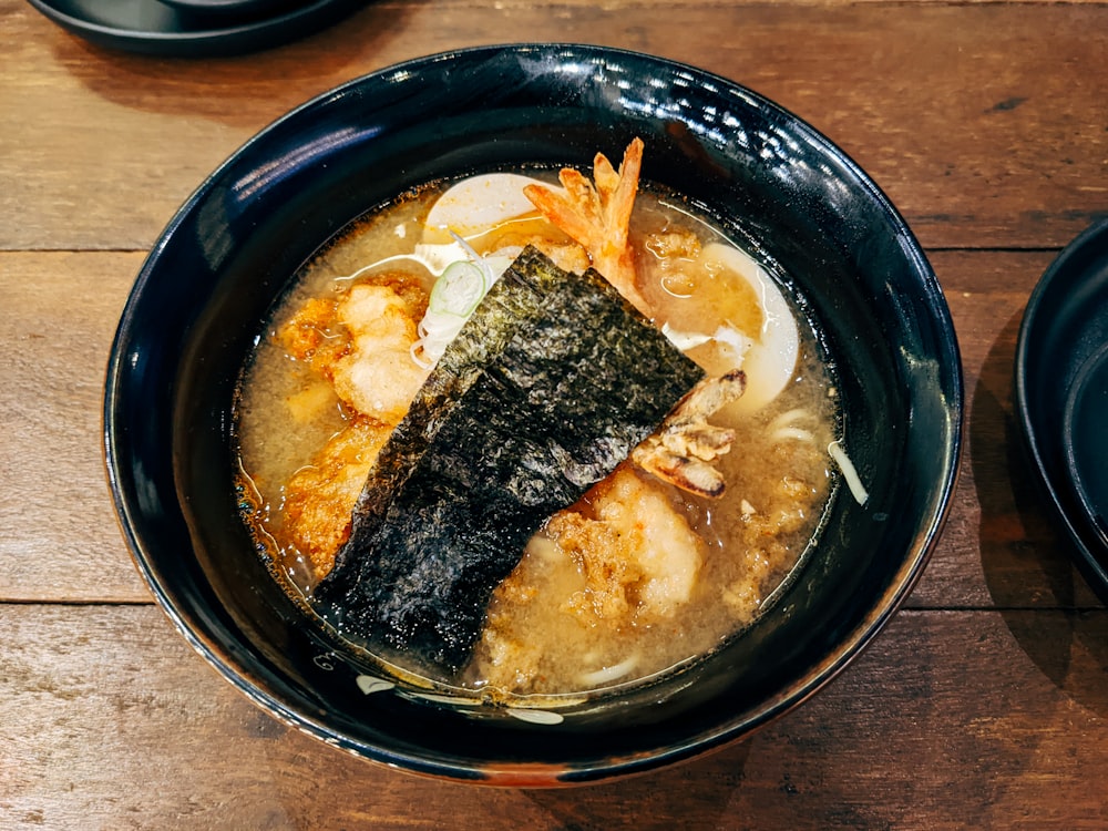 a bowl of food on a wooden table