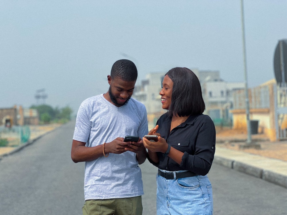 a man and a woman looking at a cell phone