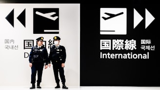 two police officers standing in front of a black and white sign