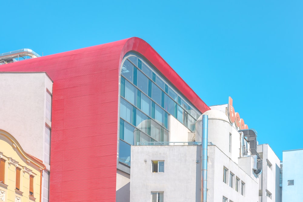 a red and white building with a red roof