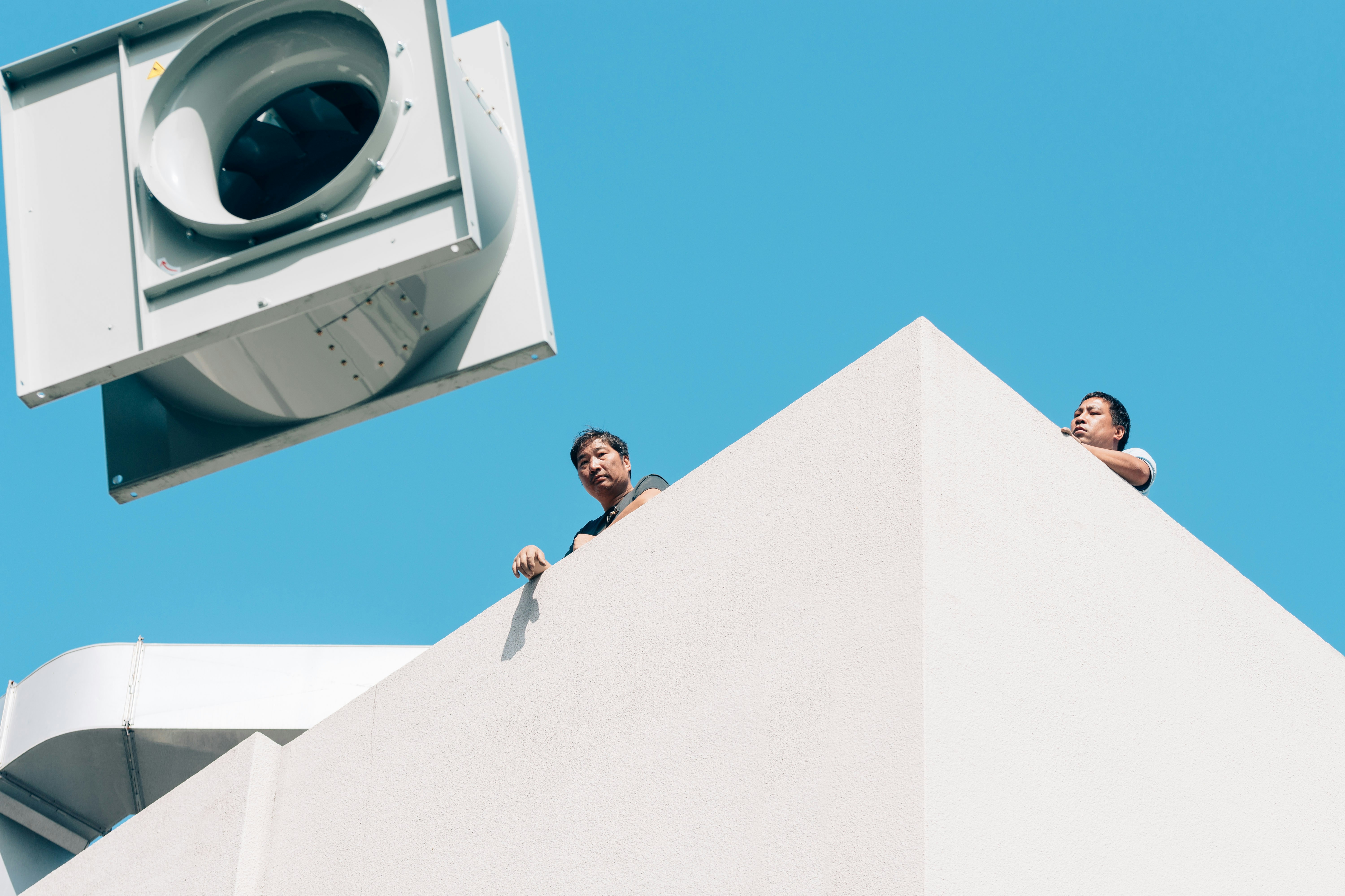 a couple of people standing on top of a building