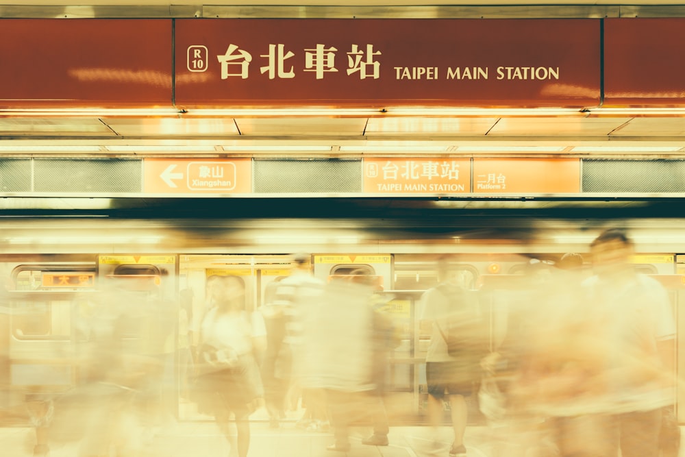 a group of people standing on a train platform