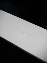 A sleek, minimalistic package box with the flowvista logo glowing softly in the background