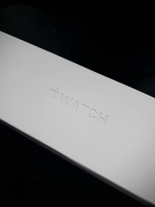 A sleek, minimalistic package box with the flowvista logo glowing softly in the background