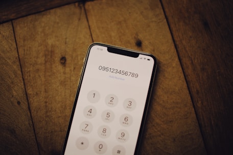 a cell phone sitting on top of a wooden table
