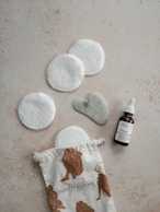 a bottle of essential oils next to a small pouch