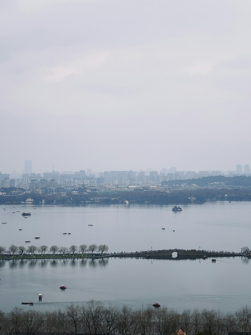 a large body of water with a city in the background