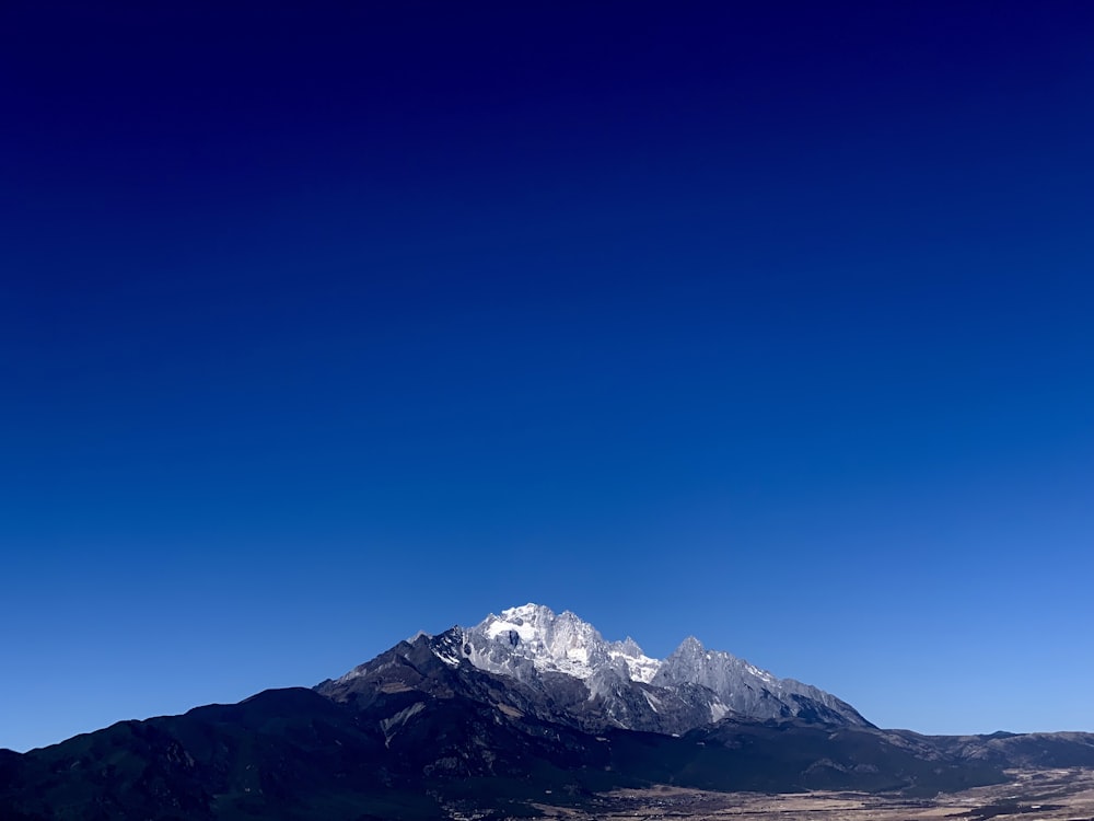 a mountain range with a clear blue sky in the background