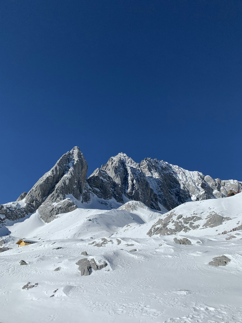 a man riding skis down a snow covered slope