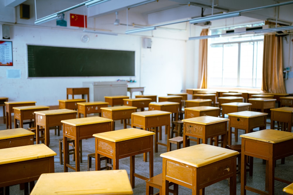 a classroom filled with lots of wooden desks