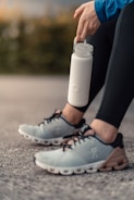 Close-up of hands holding a water bottle during exercise