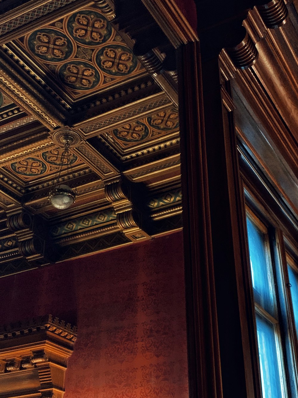 a room with a clock and a decorative ceiling