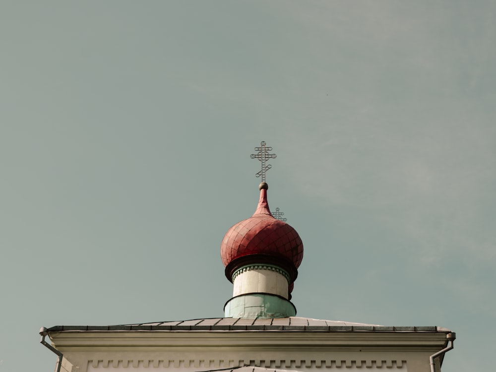 a red and white building with a cross on top