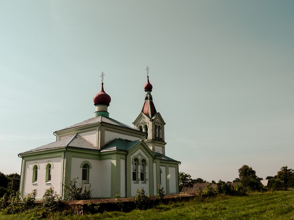 a white and green church with two towers