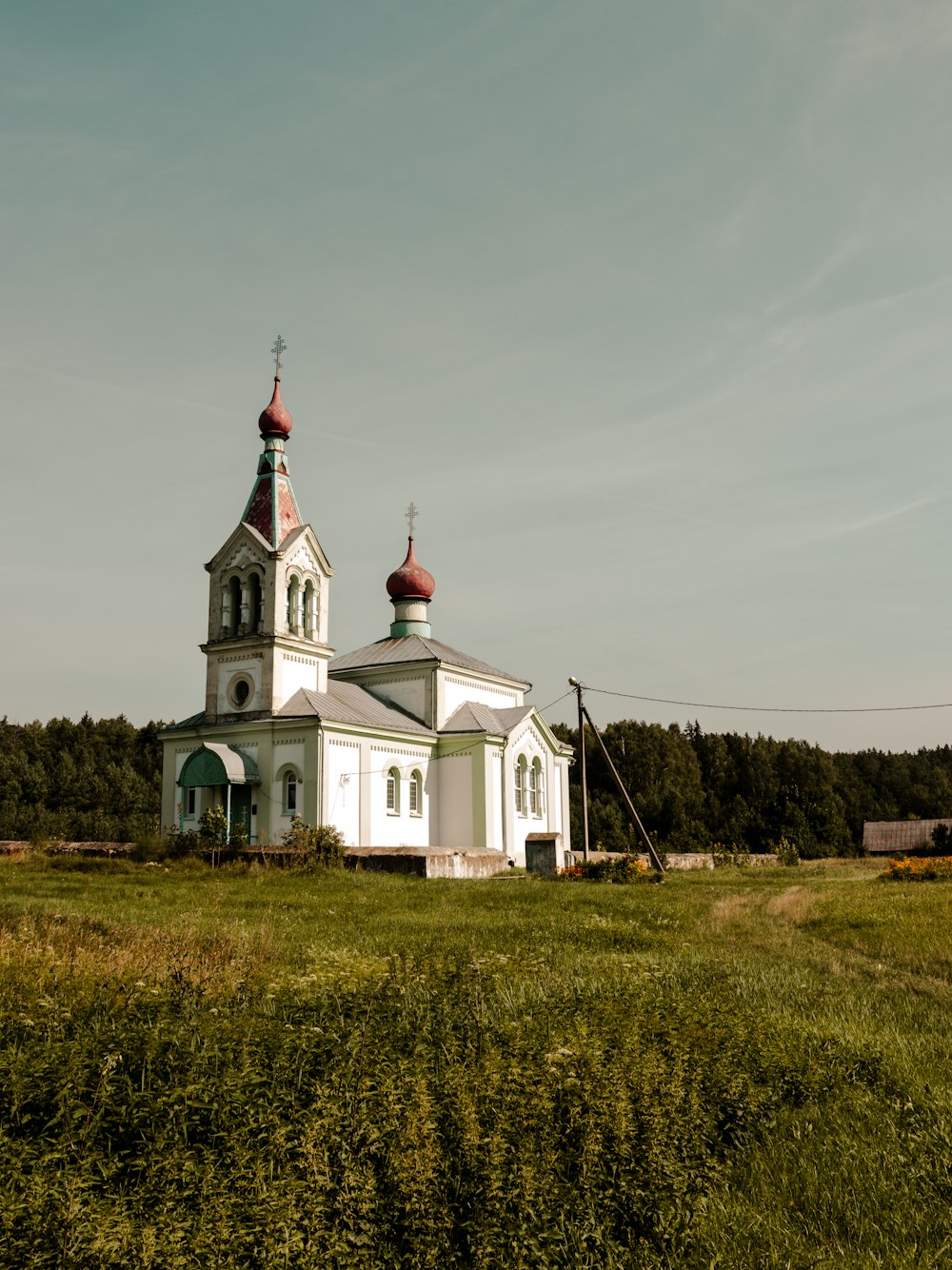 a church in the middle of a grassy field