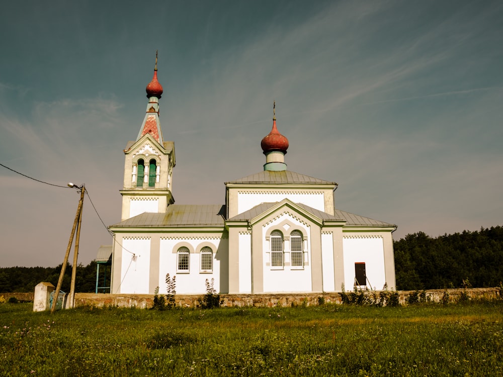 a large white church with two red domes
