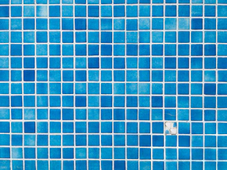 a close up of a blue tiled wall