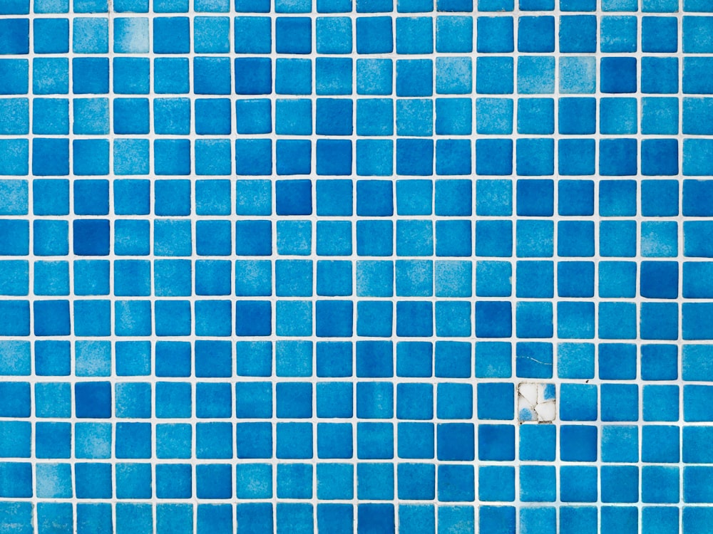 a close up of a blue tiled wall