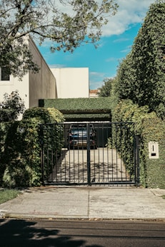 a car is parked in front of a gate