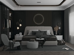 a bedroom with a large bed and a chair