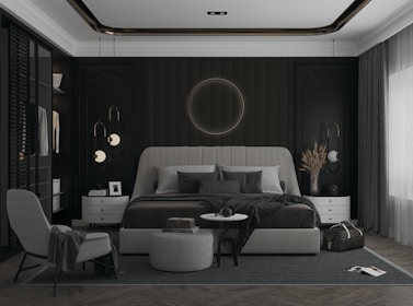 An elegant bedroom with minimalist furniture, a rich black backdrop, and golden highlights illuminating the woodwork.