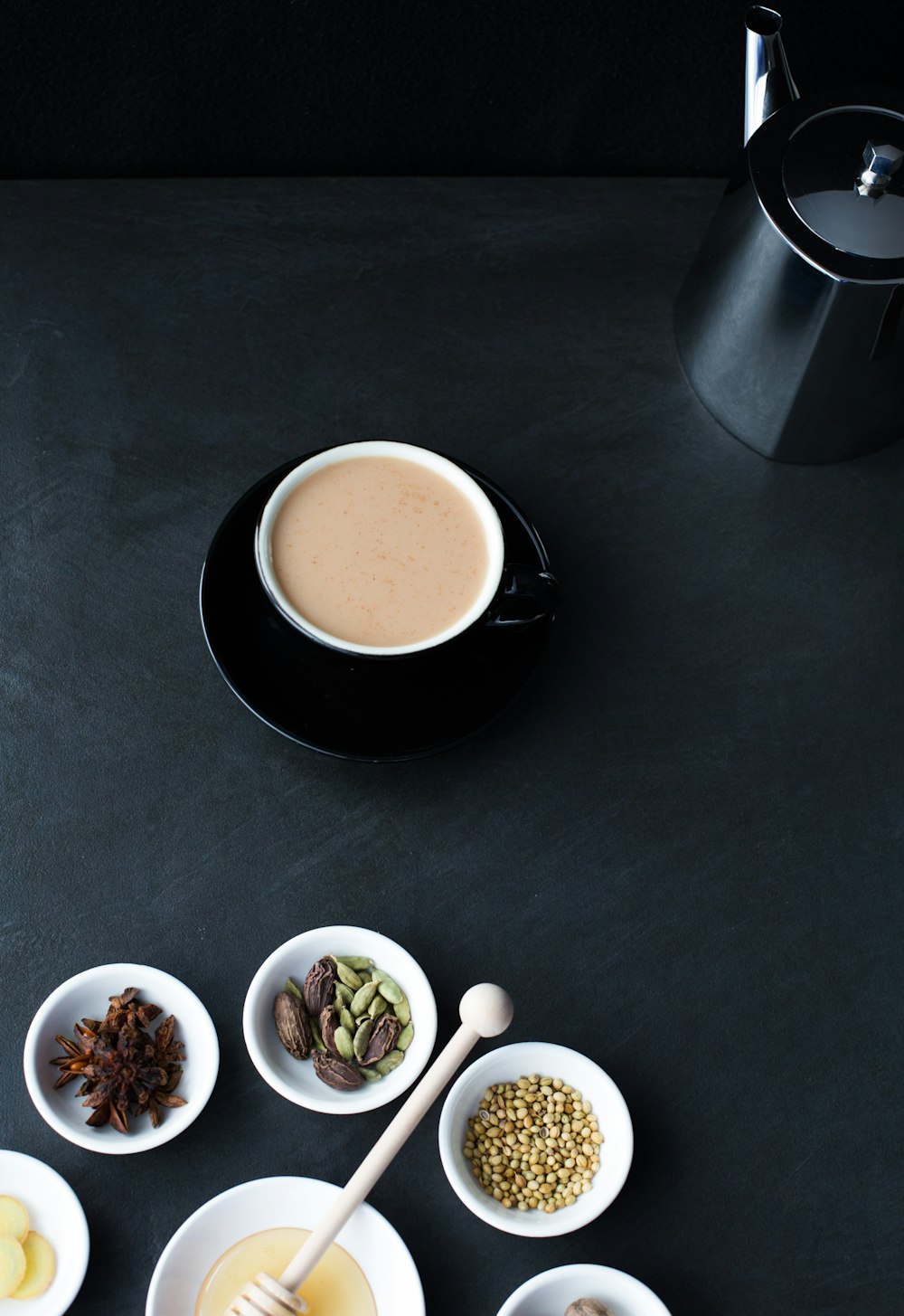 a table topped with bowls of food and a cup of coffee